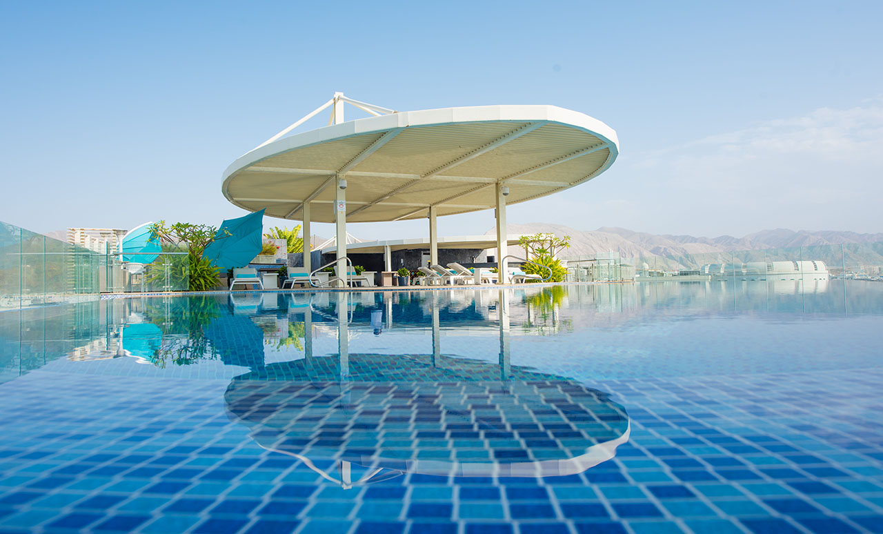 GMM Hero Image - Hotel Rooftop Pool with Mountain and SKy view